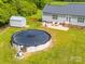 Backyard view of the house with above ground pool, patio, shed, and fencing at 2225 Corinth Church Rd, Monroe, NC 28112