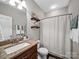Well-lit bathroom featuring a granite countertop, decorative shelving, and tiled floors at 2225 Corinth Church Rd, Monroe, NC 28112