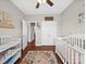 Bedroom with hardwood floors, 2 white cribs and a view to the home's hallway at 2225 Corinth Church Rd, Monroe, NC 28112