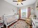 Cozy Bedroom featuring a white crib, hardwood floors, and natural light at 2225 Corinth Church Rd, Monroe, NC 28112