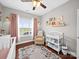 This Bedroom boasts a white crib, hardwood floors, and a cozy armchair at 2225 Corinth Church Rd, Monroe, NC 28112