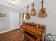 Inviting entryway featuring hardwood floors, a charming piano, and decorative guitars hanging on the wall at 2225 Corinth Church Rd, Monroe, NC 28112