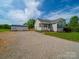 One-story home with shed, gravel driveway, and well-manicured lawn at 2225 Corinth Church Rd, Monroe, NC 28112