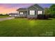 Charming single-Gathering home featuring a large front yard, cozy porch, and a detached storage shed at 2225 Corinth Church Rd, Monroe, NC 28112