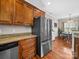 Kitchen featuring stainless steel refrigerator, dishwasher, granite countertops, and wood cabinets at 2225 Corinth Church Rd, Monroe, NC 28112