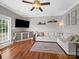 Bright living room with hardwood floors, comfortable seating, and a modern ceiling fan for a welcoming space at 2225 Corinth Church Rd, Monroe, NC 28112