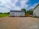 New storage shed with a metal roof, matching doors and windows, and gravel for access and drainage at 2225 Corinth Church Rd, Monroe, NC 28112