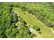 Expansive aerial view showcasing the property, including a long lawn, pool, and wooded area at 237 Fea Ln, Iron Station, NC 28080