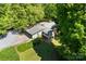 Aerial view of a home with lush landscaping, offering privacy and a serene setting in a verdant neighborhood at 237 Fea Ln, Iron Station, NC 28080