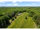 Expansive aerial view of property with outbuildings surrounded by lush greenery at 237 Fea Ln, Iron Station, NC 28080