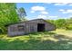 Rustic barn on a lush green lot, perfect for storage or hobbies with window and open bay at 237 Fea Ln, Iron Station, NC 28080