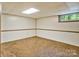 Clean and well-maintained unfinished basement space with a window at 237 Fea Ln, Iron Station, NC 28080