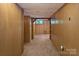 View of the partially-finished basement featuring paneled walls and classic carpeting at 237 Fea Ln, Iron Station, NC 28080