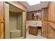 Basement bathroom with wood paneling and a walk-in shower at 237 Fea Ln, Iron Station, NC 28080