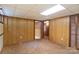 Spacious basement hallway with wood paneling and multiple doorways at 237 Fea Ln, Iron Station, NC 28080