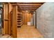 Unfinished basement with exposed utilities and ample storage shelving at 237 Fea Ln, Iron Station, NC 28080