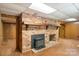 Cozy basement boasting a brick fireplace with a wood-burning stove insert at 237 Fea Ln, Iron Station, NC 28080