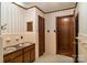 Well-lit bathroom with double sinks, tiled walls, and separate doors at 237 Fea Ln, Iron Station, NC 28080