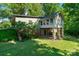 Unique home exterior featuring a sunroom on stilts and outdoor patio at 237 Fea Ln, Iron Station, NC 28080
