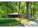 Charming home exterior with a covered porch, wood columns, and lush greenery at 237 Fea Ln, Iron Station, NC 28080