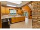 Rustic kitchen featuring wood cabinets, stainless appliances, exposed beams, and a vaulted ceiling at 237 Fea Ln, Iron Station, NC 28080