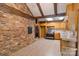 Rustic kitchen featuring brick accent wall, wood cabinets, and stainless appliances at 237 Fea Ln, Iron Station, NC 28080