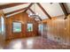 Cozy living room with wood paneling, unique light fixture, and ample natural light at 237 Fea Ln, Iron Station, NC 28080