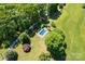 Aerial view of a sparkling in-ground pool and landscaped yard, perfect for outdoor recreation at 237 Fea Ln, Iron Station, NC 28080