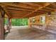 Spacious porch with a wood ceiling, brick walls, and a bench for relaxation at 237 Fea Ln, Iron Station, NC 28080