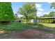 Expansive property showcasing a barn, sheds, and serene, green landscape at 237 Fea Ln, Iron Station, NC 28080