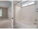 Bathroom showcasing a tub with shower and a glimpse into the bedroom at 2412 Laura Dr, Charlotte, NC 28212
