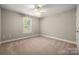 Bedroom showcases bright window, ceiling fan, and carpet at 2412 Laura Dr, Charlotte, NC 28212