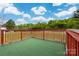 Exterior shot of the deck against a backdrop of green trees and cloudy skies at 2412 Laura Dr, Charlotte, NC 28212