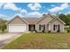 Charming single-story home with a well-manicured lawn, attached garage, and classic curb appeal at 2412 Laura Dr, Charlotte, NC 28212