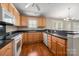 Well-lit kitchen featuring wood cabinets, granite counters, and modern appliances for cooking at 2412 Laura Dr, Charlotte, NC 28212