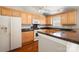Functional kitchen with wooden cabinetry, granite countertops, and essential appliances at 2412 Laura Dr, Charlotte, NC 28212