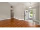 Inviting living room with gleaming hardwood floors, neutral paint, and a bright entry area at 2412 Laura Dr, Charlotte, NC 28212