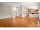 Spacious living area featuring hardwood floors, vaulted ceiling, and seamless flow to the kitchen at 2412 Laura Dr, Charlotte, NC 28212