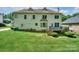 Two-story home featuring a spacious backyard, wooden deck, and light yellow siding at 3119 Castlemaine Dr, Charlotte, NC 28269