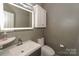 Modern half bath with an LED mirror and floating vanity at 3119 Castlemaine Dr, Charlotte, NC 28269
