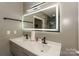 Contemporary bathroom featuring double sinks, modern fixtures, and sleek, illuminated mirror at 3119 Castlemaine Dr, Charlotte, NC 28269