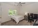 Bright bedroom with neutral decor, carpet, window, and desk with computer at 3119 Castlemaine Dr, Charlotte, NC 28269