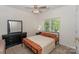Comfortable bedroom featuring a classic metal frame bed, dresser, and bright window at 3119 Castlemaine Dr, Charlotte, NC 28269