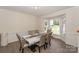 Dining room with bay windows and neutral walls. The table seats six at 3119 Castlemaine Dr, Charlotte, NC 28269
