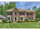 Elegant two-story brick home with manicured lawn and lovely landscaping at 3119 Castlemaine Dr, Charlotte, NC 28269