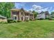 Beautiful brick home with a well-manicured lawn and mature landscaping at 3119 Castlemaine Dr, Charlotte, NC 28269