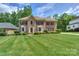 Well-maintained brick home featuring a large lawn and mature trees at 3119 Castlemaine Dr, Charlotte, NC 28269