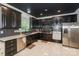 Modern kitchen featuring dark cabinets, stainless steel appliances, mosaic backsplash, and marble tile flooring at 3119 Castlemaine Dr, Charlotte, NC 28269