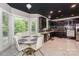 Kitchen and breakfast nook with a view, showcasing dark cabinets, stainless appliances, and marble flooring at 3119 Castlemaine Dr, Charlotte, NC 28269