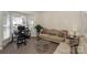 Comfortable sitting area with a beige sofa, glass coffee table, and natural lighting at 3119 Castlemaine Dr, Charlotte, NC 28269